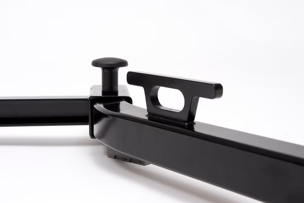 Close-up of a black metal tie down on TuckRack on a white background