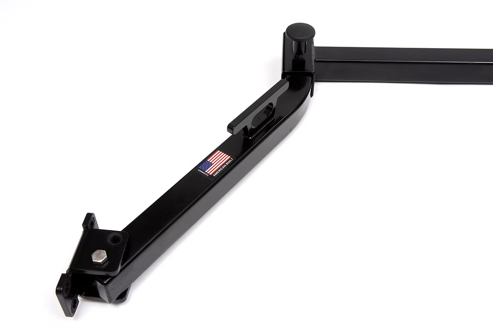 Black metal TuckRack bracket with an American flag emblem on a white background
